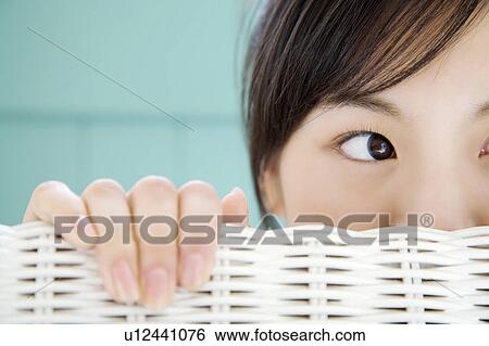 Woman who lets a face peep out from a chair View Large Photo Image Stock Photograph - Woman who lets a face peep out from a chair. Fotosearch