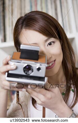 Woman who takes a photograph View Large Photo Image Stock Image - Woman who takes a photograph. Fotosearch