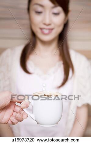 Stock Image - Woman who waits for coffee. Fotosearch