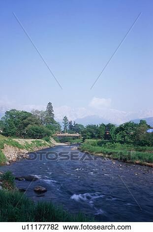 Stock Image - Bridge over river in Nagano Prefecture, Japan. Fotosearch