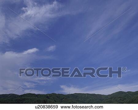 Stock Photo - Mountain range and blue sky. Fotosearch