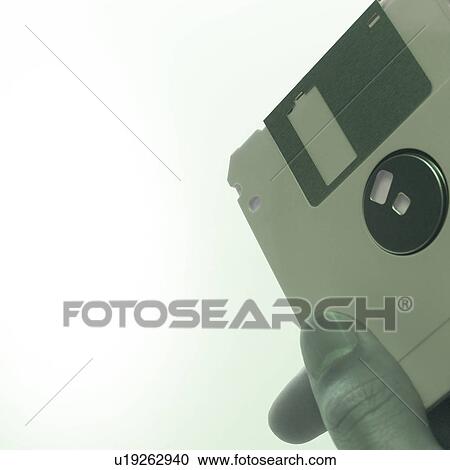 A man holding a floppy disk View Large Photo Image Stock Image - A man holding a floppy disk. Fotosearch