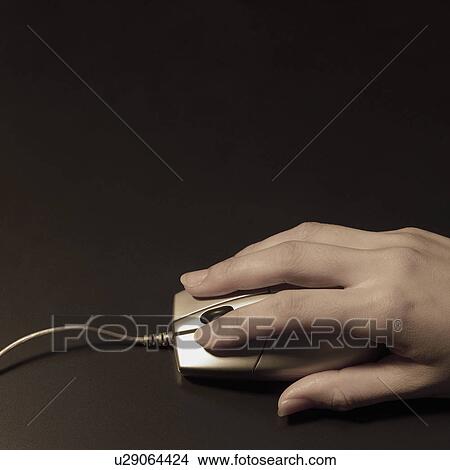 Picture - A man using computer mouse. Fotosearch