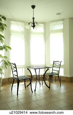 Table and chairs in room View Large Photo Image Picture - Table and chairs in room. Fotosearch