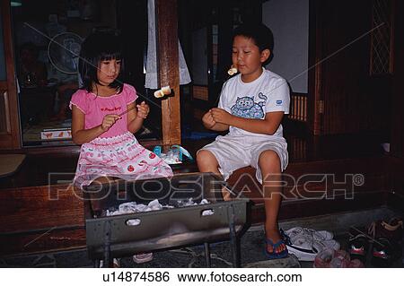 Boy and girl roasting marshmallows View Large Photo Image Stock Photograph - Boy and girl roasting marshmallows. Fotosearch