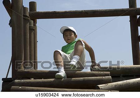 Boy playing in playground View Large Photo Image Picture - Boy playing in playground. Fotosearch