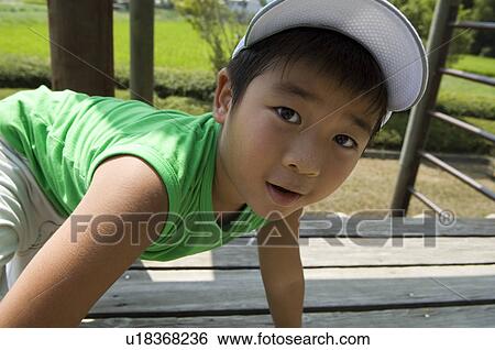 Boy playing in playground View Large Photo Image Stock Photograph - Boy playing in playground. Fotosearch