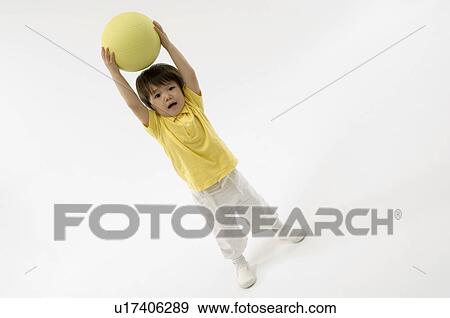 Stock Photo - Boy playing with ball. Fotosearch