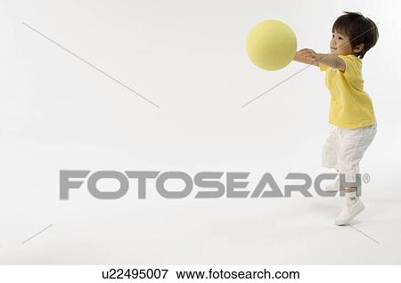Stock Photo - Boy playing with ball. Fotosearch