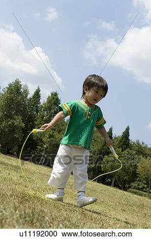 Boy playing with jump rope View Large Photo Image Stock Image - Boy playing with jump rope. Fotosearch