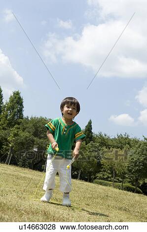 Stock Photo - Boy playing with jump rope. Fotosearch