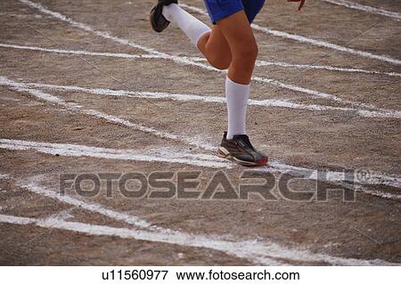 Stock Photo - Boy running in school sports race. Fotosearch