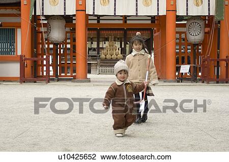Brother and sister at shrine View Large Photo Image Stock Image - Brother and sister at shrine. Fotosearch