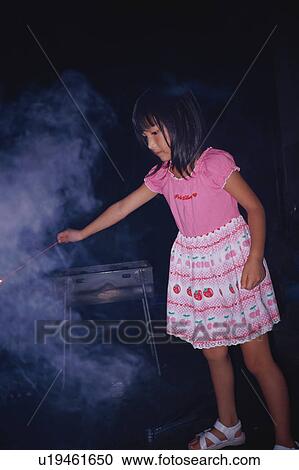 Girl holding sparkler View Large Photo Image Stock Image - Girl holding sparkler. Fotosearch
