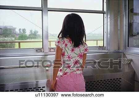 Stock Photo - Girl on train looking out window. Fotosearch