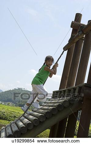 Girl playing in playground View Large Photo Image Picture - Girl playing in playground. Fotosearch
