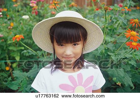 Girl wearing straw hat looking at camera View Large Photo Image Stock Image - Girl wearing straw hat looking at camera. Fotosearch