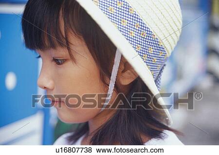 Girl wearing straw hat View Large Photo Image Stock Photo - Girl wearing straw hat. Fotosearch