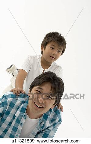 Stock Photo - Son sitting on father's back. Fotosearch