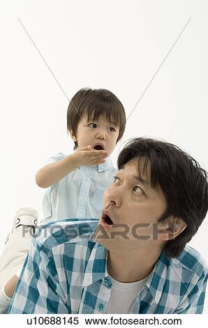 Son sitting on father's back View Large Photo Image Stock Photography - Son sitting on father's back. Fotosearch