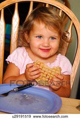 Close-up of a girl eating a pie View Large Photo Image Stock Photo - Close-up of a girl eating a pie. Fotosearch