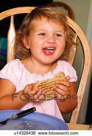 Close-up of a girl eating a pie View Large Photo Image Stock Photograph - Close-up of a girl eating a pie. Fotosearch