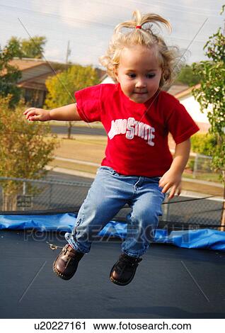 Stock Image - Close-up of a girl jumping. Fotosearch