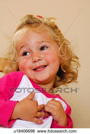 Close-up of a girl smiling View Large Photo Image Stock Photo - Close-up of a girl smiling. Fotosearch