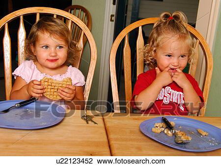 Close-up of two girls eating pies View Large Photo Image Stock Image - Close-up of two girls eating pies. Fotosearch