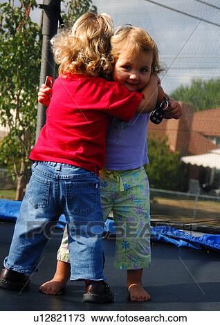 Close-up of two girls hugging each other View Large Photo Image Stock Image - Close-up of two girls hugging each other. Fotosearch