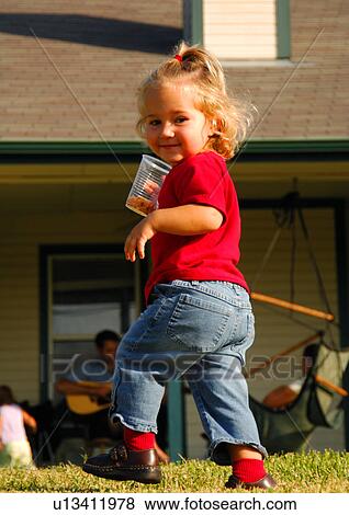 Portrait of a girl holding a disposable glass View Large Photo Image Stock Photo - Portrait of a girl holding a disposable glass. Fotosearch