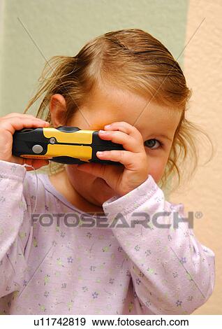 Portrait of a girl taking a photo with a toy camera View Large Photo Image Stock Photo - Portrait of a girl taking a photo with a toy camera. Fotosearch