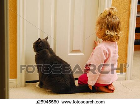 Rear view of a girl kneeling on the floor with a cat View Large Photo Image Stock Image - Rear view of a girl kneeling on the floor with a cat. Fotosearch