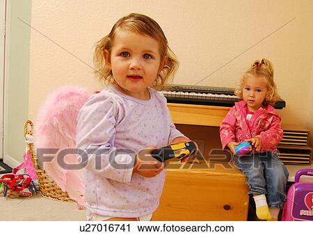 Two girls playing with toys View Large Photo Image Stock Image - Two girls playing with toys. Fotosearch