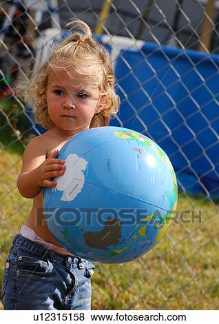 Close-up of a girl holding a globe View Large Photo Image Stock Photo - Close-up of a girl holding a globe. Fotosearch