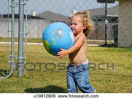 Close-up of a girl holding a globe View Large Photo Image Stock Photo - Close-up of a girl holding a globe. Fotosearch
