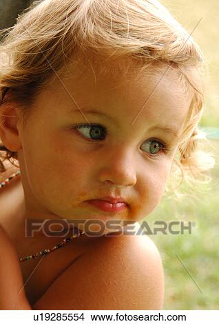 Picture - Close-up of a girl looking over her shoulder. Fotosearch