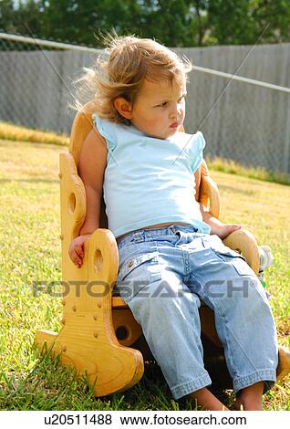 Stock Photo - Close-up of a girl sitting in a chair. Fotosearch