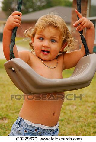 Close-up of a girl standing in a park and holding a swing View Large Photo Image Stock Image - Close-up of a girl standing in a park and holding a swing. Fotosearch