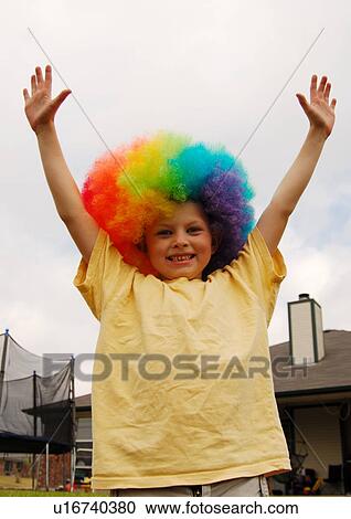 Portrait of a boy wearing a multi-colored wig and smiling View Large Photo Image Stock Image - Portrait of a boy wearing a multi-colored wig and smiling. Fotosearch