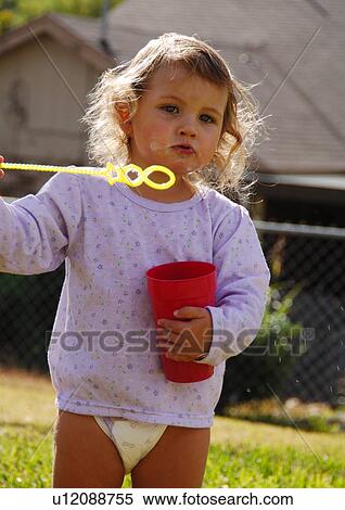 Portrait of a girl blowing bubbles View Large Photo Image Stock Photography - Portrait of a girl blowing bubbles. Fotosearch