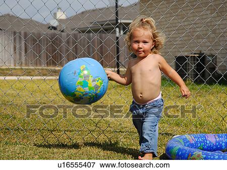 Stock Photo - Portrait of a girl playing with a globe. Fotosearch