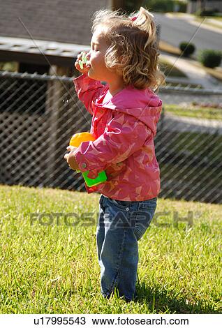 Side profile of a girl blowing bubbles with a bubble wand View Large Photo Image Stock Image - Side profile of a girl blowing bubbles with a bubble wand. Fotosearch