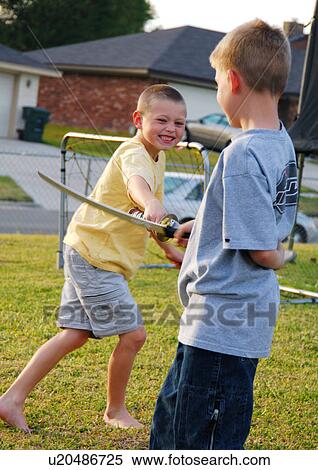 Two boys playfighting with swords View Large Photo Image Stock Photography - Two boys playfighting with swords. Fotosearch