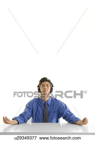Businessman practicing yoga and listening to music View Large Photo Image Stock Photo - Businessman practicing yoga and listening to music. Fotosearch
