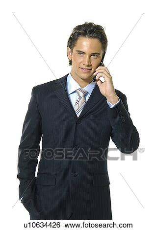 Businessman talking on a mobile phone and smiling View Large Photo Image Stock Photograph - Businessman talking on a mobile phone and smiling. Fotosearch