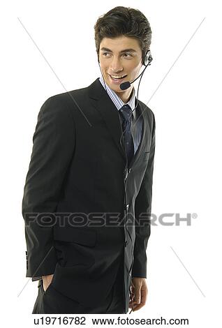 Stock Image - Businessman wearing headset and smiling. Fotosearch