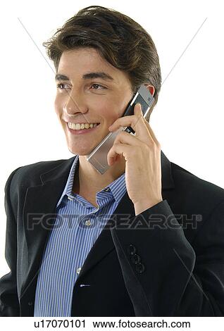 Stock Image - Close-up of a businessman talking on a mobile phone and smiling. Fotosearch