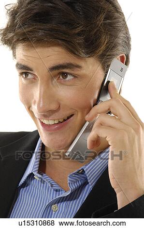 Close-up of a businessman talking on a mobile phone and smiling View Large Photo Image Stock Photo - Close-up of a businessman talking on a mobile phone and smiling. Fotosearch