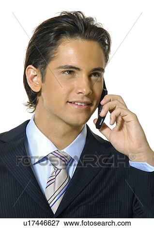 Close-up of a businessman talking on a mobile phone and smiling View Large Photo Image Stock Photo - Close-up of a businessman talking on a mobile phone and smiling. Fotosearch